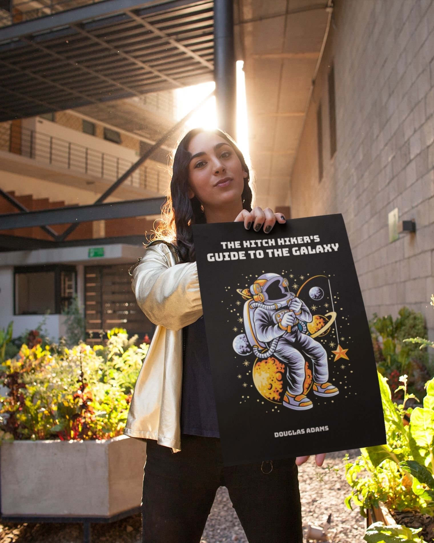 The-hitchhikers-guide-to-the-galaxy-douglas-adams-person-holding-poster-courtyard-musings-of-a-reader